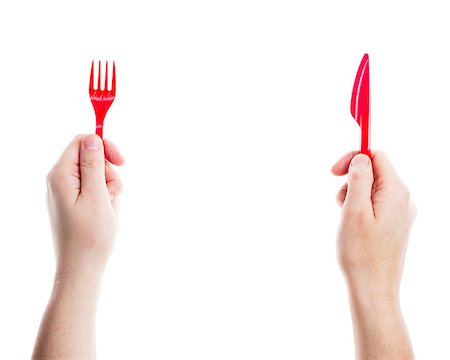 Red disposable knife and fork in hands isolated on white background Stock Photo - Budget Royalty-Free & Subscription, Code: 400-07292171