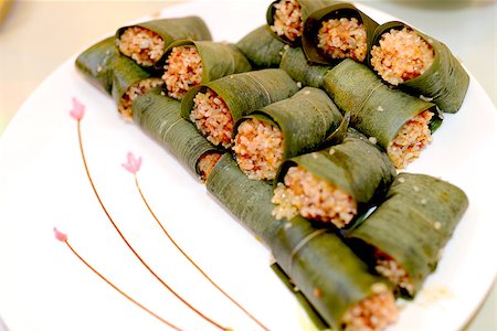 simsearch:400-04025064,k - Sticky rice wrapped and steamed in bamboo leaves on a white plate Stock Photo - Budget Royalty-Free & Subscription, Code: 400-07292738
