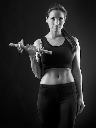 Photo of an attractive female doing a dumbbell curl black and white version. Foto de stock - Super Valor sin royalties y Suscripción, Código: 400-07292792