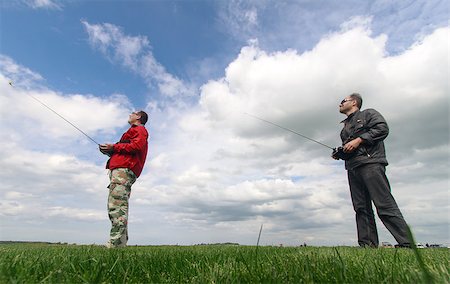 simsearch:400-08613554,k - Two Man controls RC gliders in the sky Stock Photo - Budget Royalty-Free & Subscription, Code: 400-07292804