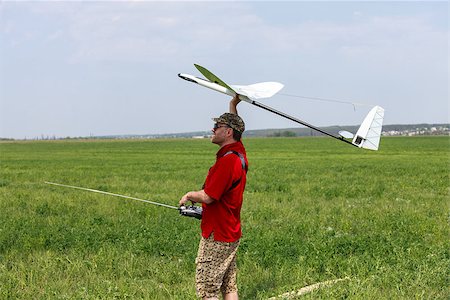 simsearch:400-08613554,k - Man launches into the blue sky RC glider Stock Photo - Budget Royalty-Free & Subscription, Code: 400-07292809