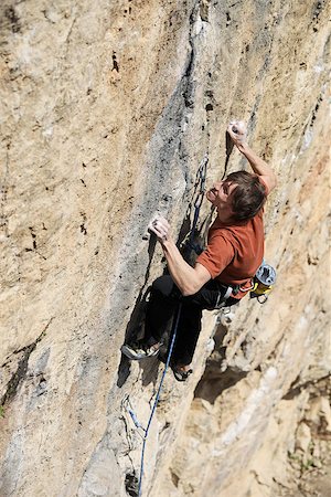 simsearch:400-07292725,k - Rock climber struggling to make next movement Photographie de stock - Aubaine LD & Abonnement, Code: 400-07292872