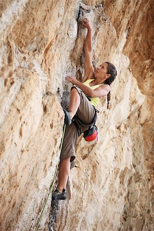 simsearch:400-07292725,k - Young female rock climber on a cliff face Photographie de stock - Aubaine LD & Abonnement, Code: 400-07292881