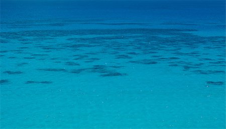 A tropical sea,with coral reef clearly visibal beneath the surface of the water Stock Photo - Budget Royalty-Free & Subscription, Code: 400-07293052