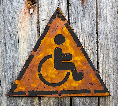 simsearch:400-07312536,k - Disabled Icon on Weathered Triangular Yellow Warning Sign. Grange Background. Stock Photo - Budget Royalty-Free & Subscription, Code: 400-07293231