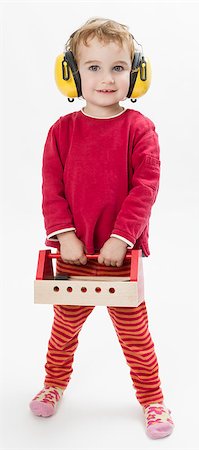 child in red clothing with toolbox and earmuffs. vertical image Foto de stock - Royalty-Free Super Valor e Assinatura, Número: 400-07293284