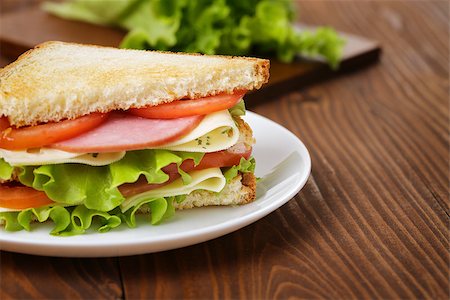 toasted sandwich with ham, cheese and vegetables, on wooden table Stock Photo - Budget Royalty-Free & Subscription, Code: 400-07293591