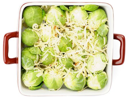 simsearch:400-07625359,k - Brussels Sprouts Casserole in Brown Polka Dot Bowl with Grated Cheese and Spices isolated on white background. Top View Photographie de stock - Aubaine LD & Abonnement, Code: 400-07293678