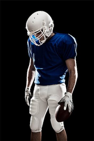 Football Player with number on a blue uniform and a ball in the hand. Studio shot. Photographie de stock - Aubaine LD & Abonnement, Code: 400-07304215