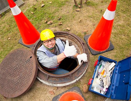 sewer - sewerage worker in the manhole with thumb up Stock Photo - Budget Royalty-Free & Subscription, Code: 400-07304337