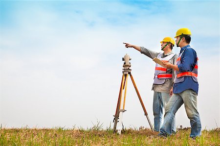 simsearch:400-07304331,k - Surveyor engineer making measure with partner on the field Stock Photo - Budget Royalty-Free & Subscription, Code: 400-07304331