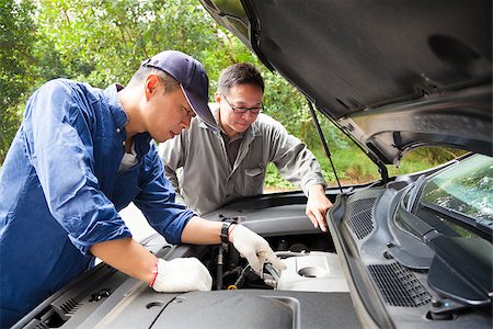 simsearch:622-02355491,k - two Mechanics  fixing the car on the road Stock Photo - Budget Royalty-Free & Subscription, Code: 400-07304340