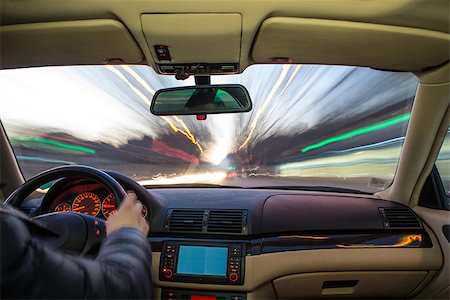 Car interior on driving. Blurred night lights Fotografie stock - Microstock e Abbonamento, Codice: 400-07304514