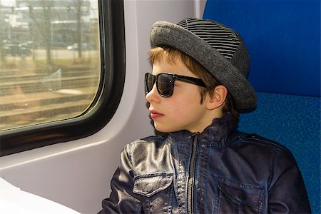 Handsome boy in sunglasses rides on a train Stock Photo - Budget Royalty-Free & Subscription, Code: 400-07304530