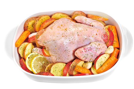 simsearch:400-05909845,k - Fresh chicken with apple, carrot, garlic, lemon, potatoes in the dripping pan. Foto de stock - Super Valor sin royalties y Suscripción, Código: 400-07304565