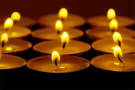 simsearch:400-04210315,k - Tea lights candles with fire on dark background Stock Photo - Budget Royalty-Free & Subscription, Code: 400-07305396
