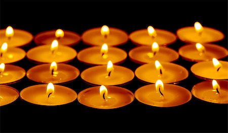 simsearch:400-04210315,k - Tea lights candles with fire on dark background Stock Photo - Budget Royalty-Free & Subscription, Code: 400-07305397