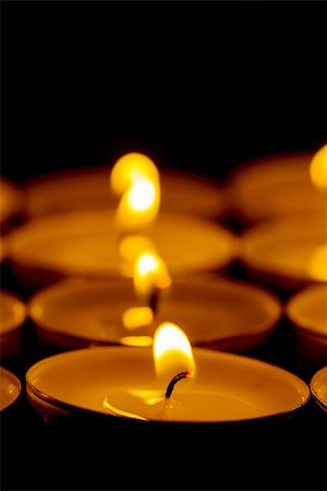 simsearch:400-04210315,k - Tea lights candles with fire on dark background Stock Photo - Budget Royalty-Free & Subscription, Code: 400-07305399