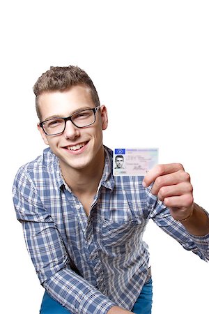 Young man just recieved his drivers license and is happy to drive his own car soon Stock Photo - Budget Royalty-Free & Subscription, Code: 400-07305436