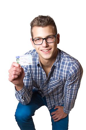 drivers licence - Young man just recieved his drivers license and is happy to drive his own car soon Stock Photo - Budget Royalty-Free & Subscription, Code: 400-07305437