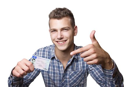 Young man just recieved his drivers license and is happy to drive his own car soon Stock Photo - Budget Royalty-Free & Subscription, Code: 400-07305439