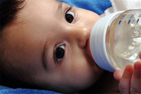 small baby holding a bottle with water Stock Photo - Budget Royalty-Free & Subscription, Code: 400-07305532
