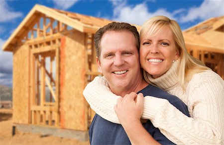 pictures of families with the sold sign on new house - Happy Excited Couple in Front of Their New Home Construction Framing Site. Stock Photo - Budget Royalty-Free & Subscription, Code: 400-07305850