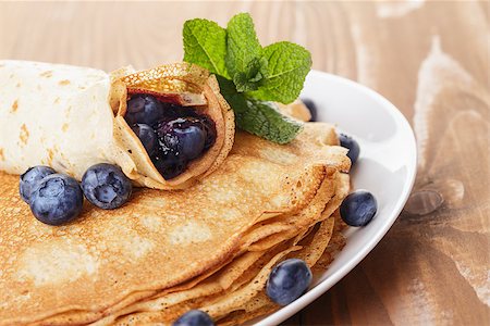homemade blinis or crepes with blueberries and jam, on wooden table Photographie de stock - Aubaine LD & Abonnement, Code: 400-07306272