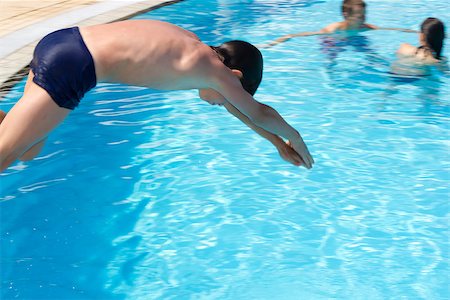 Activities on the pool. Cute boy swimming and playing in water in swimming pool Stock Photo - Budget Royalty-Free & Subscription, Code: 400-07306536