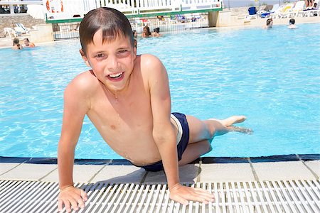 Activities on the pool. Cute boy swimming and playing in water in swimming pool Stock Photo - Budget Royalty-Free & Subscription, Code: 400-07306533