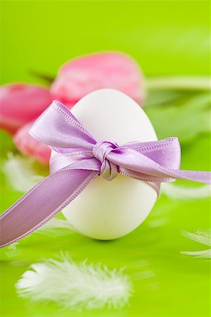 traditional easter egg decoration with tulips and ribbon green background Stock Photo - Budget Royalty-Free & Subscription, Code: 400-07306904