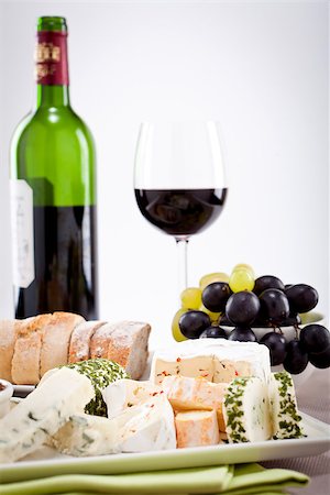 different cheese types on plate with grapes and red wine on wooden table Stock Photo - Budget Royalty-Free & Subscription, Code: 400-07307129