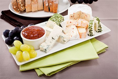 different cheese types on plate with grapes and red wine on wooden table Stock Photo - Budget Royalty-Free & Subscription, Code: 400-07307123