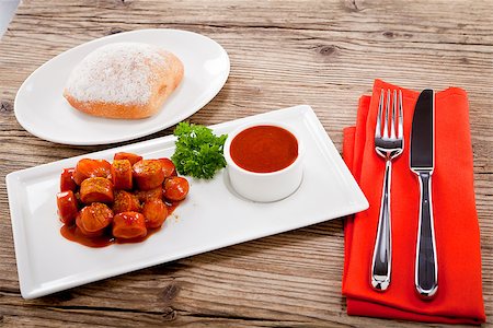 curry wurst spicy sausage with curry and ketchup on wooden background Stock Photo - Budget Royalty-Free & Subscription, Code: 400-07307139