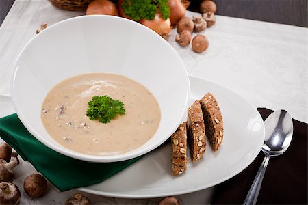 fresh chmapignon cream soup with parsley decorated on wooden table Stock Photo - Budget Royalty-Free & Subscription, Code: 400-07307151