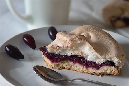 This cake is stuffed with cornel-berry jam and covered with meringue. The tart is situated on white plate and decorated with berries. Fotografie stock - Microstock e Abbonamento, Codice: 400-07307695