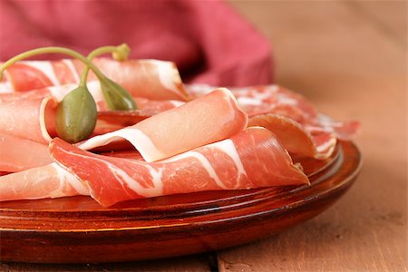 salami plate - sliced ??dried sausage meat (ham, prosciutto, salami) served on a wooden board Stock Photo - Budget Royalty-Free & Subscription, Code: 400-07307942