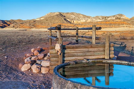 point d'eau - cattle watering hole in Red Mountain Open Space, semi desert landscape in northern Colorado near Wyoming border, late summer, reservoir fabricated from old giant tire Photographie de stock - Aubaine LD & Abonnement, Code: 400-07308103