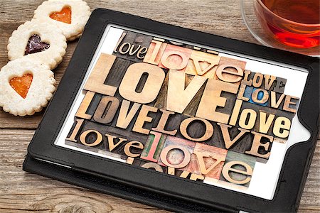 simsearch:400-07179122,k - love word abstract - in vintage letterpress wood type printing blocks on a digital tablet with cup of tea and heart cookies Stock Photo - Budget Royalty-Free & Subscription, Code: 400-07308378