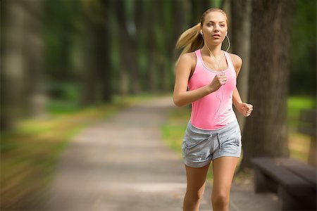 running with running shoes on a running track - Attractive young girl running in park Stock Photo - Budget Royalty-Free & Subscription, Code: 400-07300042