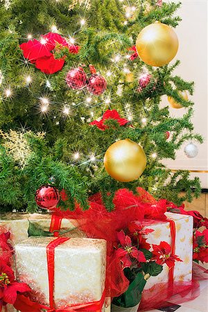 simsearch:400-07218254,k - Christmas Tree Decorated with Ornaments Poinsettia Sparkling Lights Snowflakes with Wrapped Gifts Under the Tree Stock Photo - Budget Royalty-Free & Subscription, Code: 400-07300196