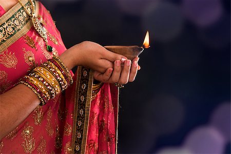 simsearch:400-08223620,k - Diwali or deepavali photo with female hands holding oil lamp during festival of light Stock Photo - Budget Royalty-Free & Subscription, Code: 400-07300501