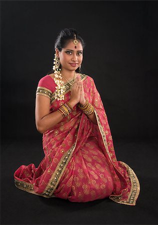 simsearch:400-08223620,k - Indian girl in a greeting pose, traditional sari costume, full length kneeling on floor isolated on black background Stock Photo - Budget Royalty-Free & Subscription, Code: 400-07300502