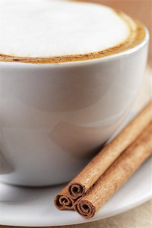 simsearch:400-07299272,k - cup of fresh hot cappuccino with cinnamon sticks, on wooden table Fotografie stock - Microstock e Abbonamento, Codice: 400-07301331