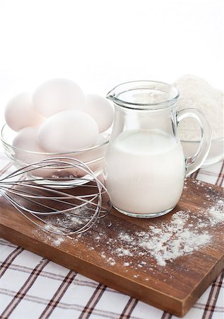 eggs milk - Baking ingredients with milk, eggs, whisk and flour on the table Stock Photo - Budget Royalty-Free & Subscription, Code: 400-07301541