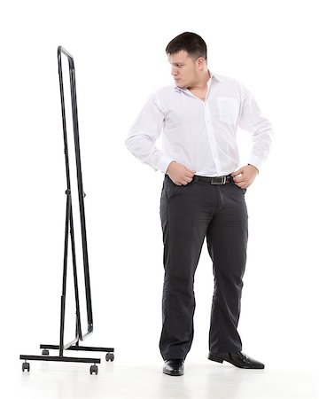 simsearch:400-07301601,k - Overweight man admiring himself in a standing mirror as he checks the fit of his clothing and his appearance while dressing in the morning Stock Photo - Budget Royalty-Free & Subscription, Code: 400-07301605