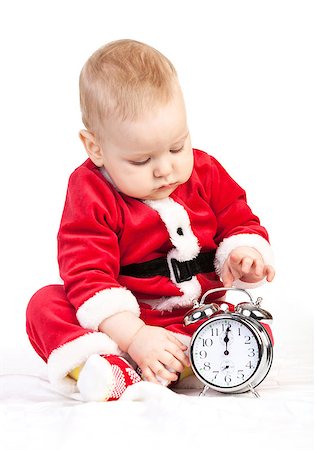 Cute little boy in Santa costume playing with alarm clock saying 12 p.m. Stock Photo - Budget Royalty-Free & Subscription, Code: 400-07301691