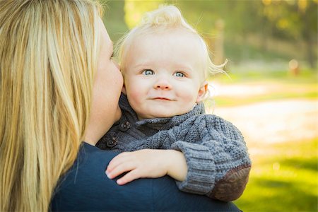 Mother Embracing Her Adorable Blonde Haired Blue Eyed Baby Boy Outdoors. Stock Photo - Budget Royalty-Free & Subscription, Code: 400-07302002