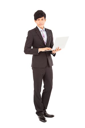 simsearch:400-07514126,k - young businessman standing with laptop Fotografie stock - Microstock e Abbonamento, Codice: 400-07302353