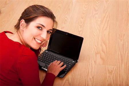 study online at home - Beautiful woman lying on the floor and working with a laptop Stock Photo - Budget Royalty-Free & Subscription, Code: 400-07302582